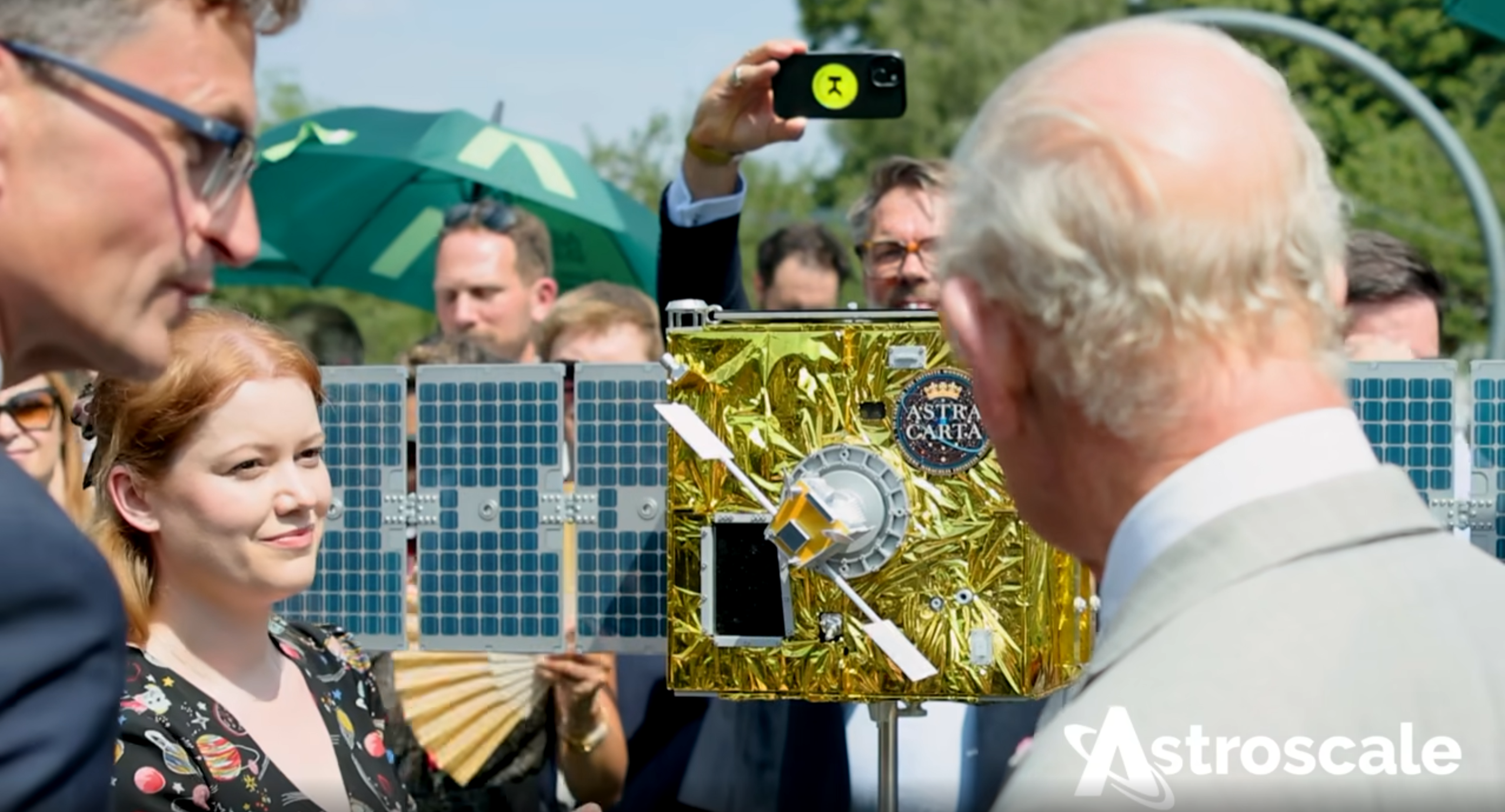 King Charles III viewing an Astroscale servicer and client spacecraft model during a mission demonstration