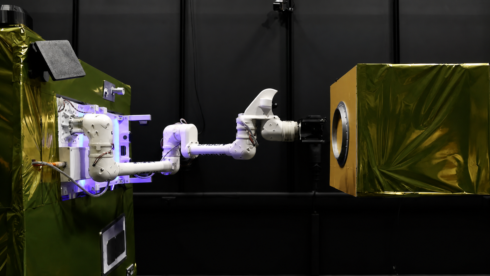 A multi-jointed robotic arm demonstrating spacecraft capture between two representative satellite structures