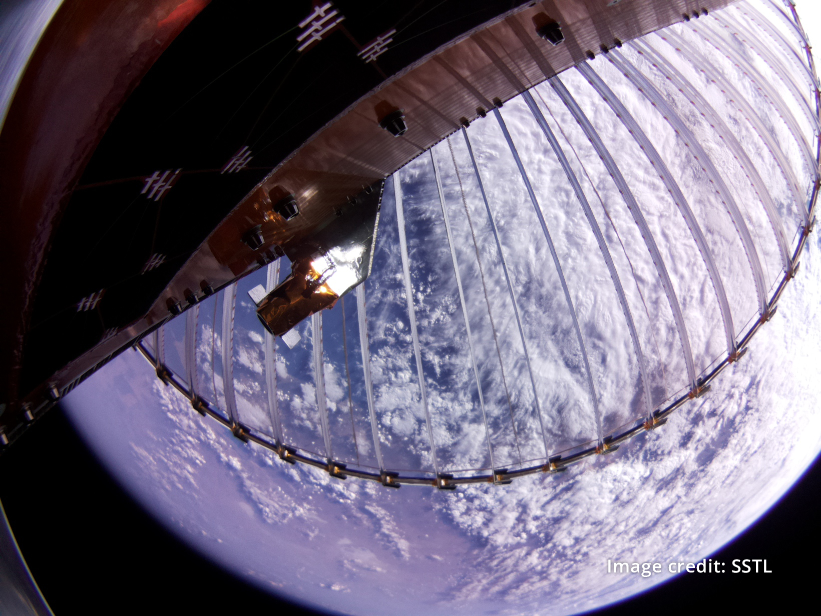 Wrapped-Rib antenna deployed above Earth in orbit aboard the CarbSAR spacecraft
